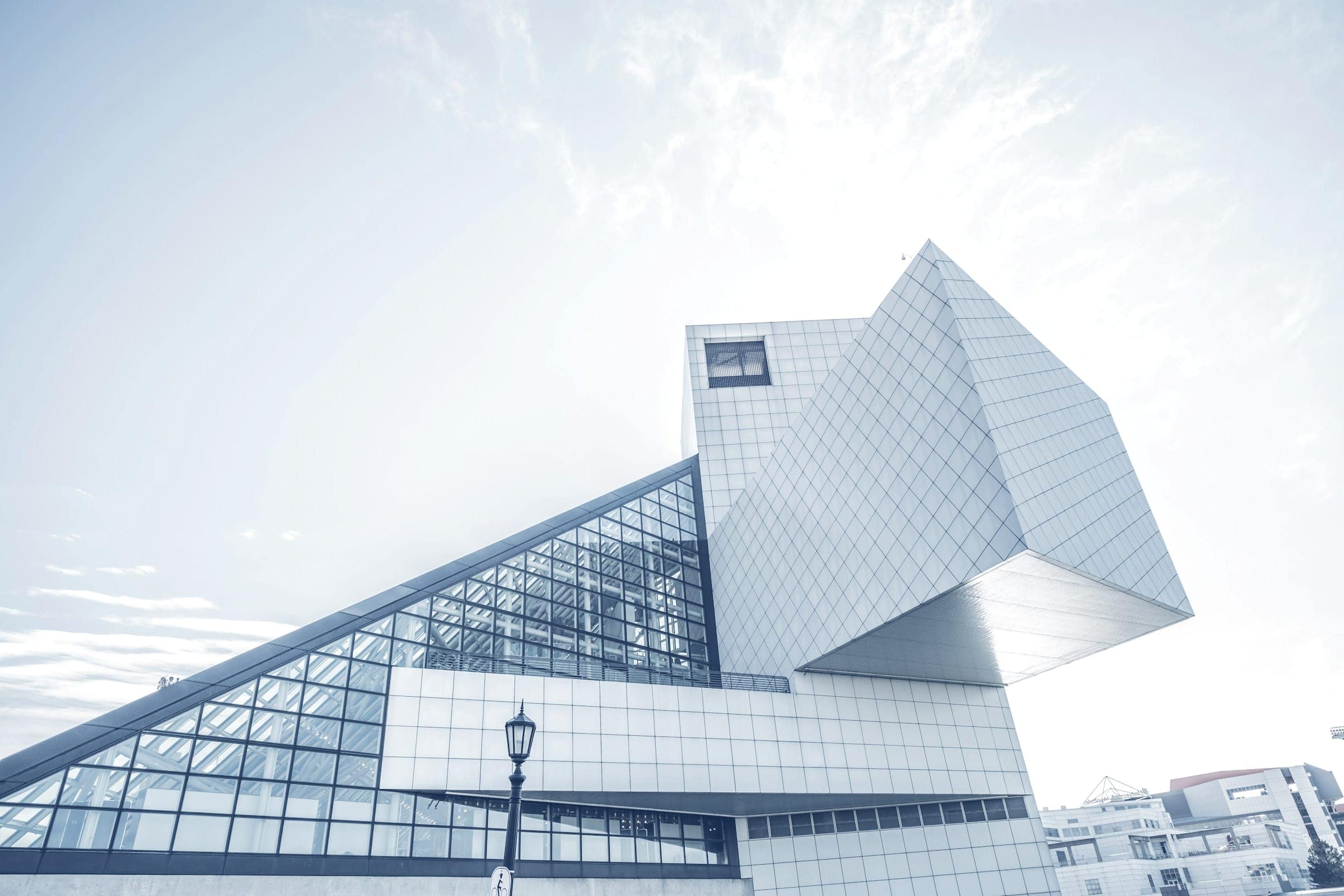 Angular white and glass facade against a pale sky