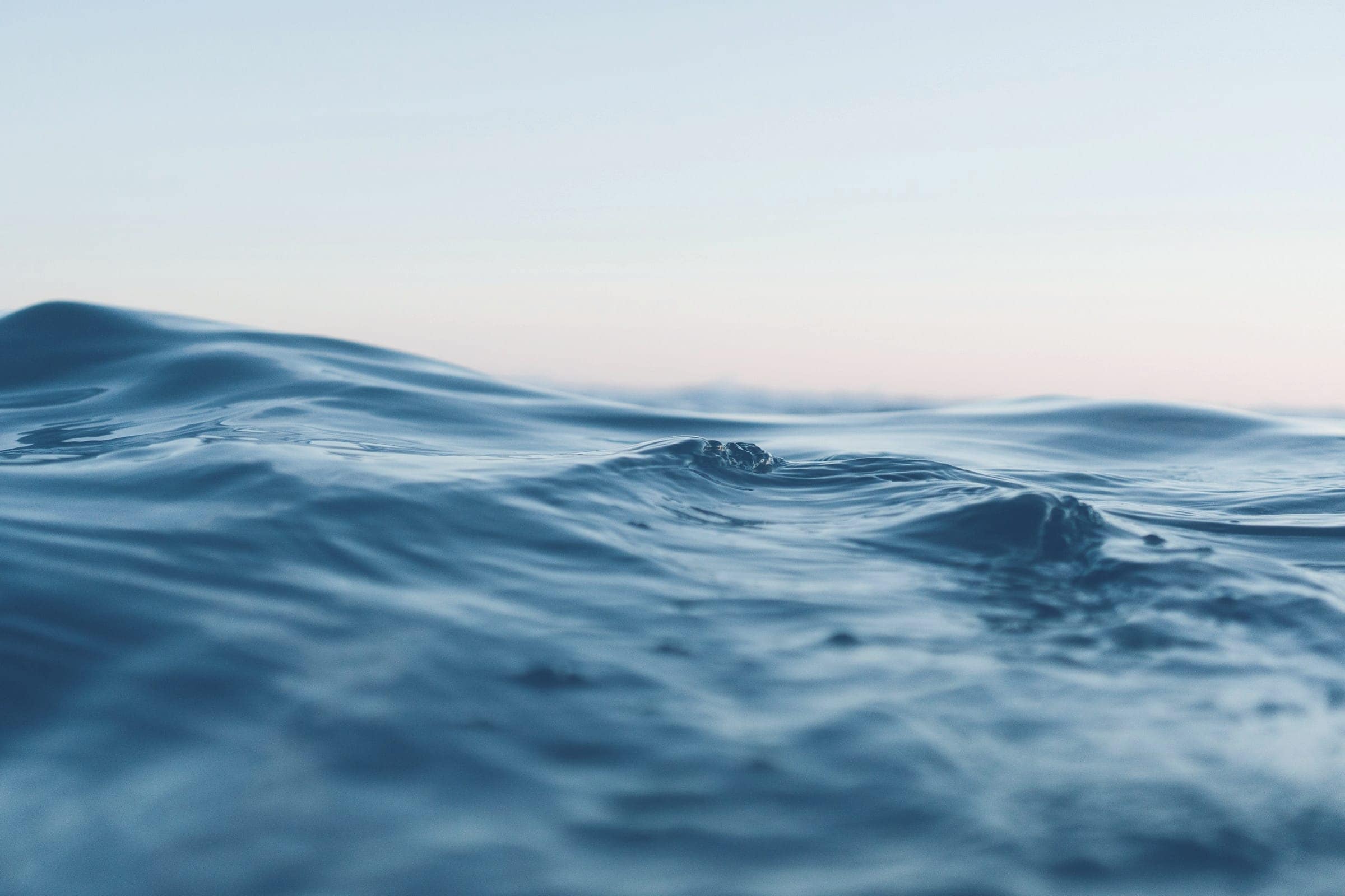 Dark open sea under a pale evening sky