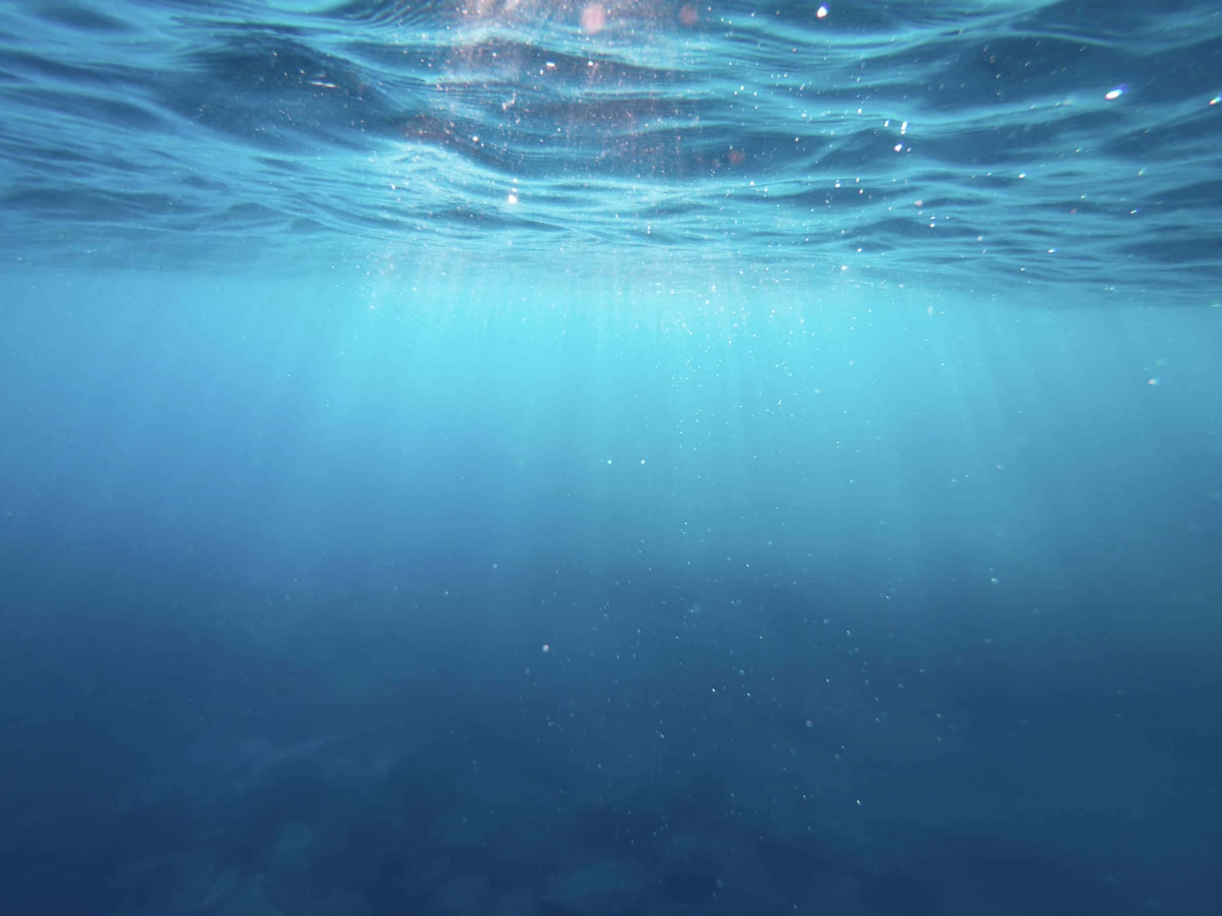 Light falling through deep blue water