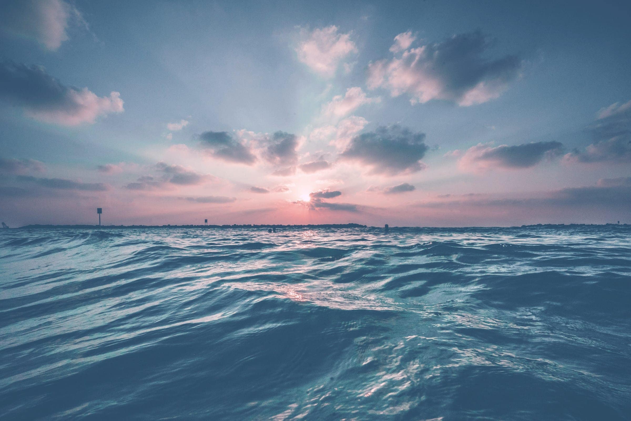 Waves rolling under a clouded evening sky